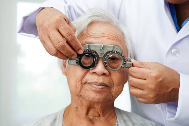 istock Optometrist checking Asian elderly woman ophthalmic vision eye test and using optical trial frame. 2170619348
