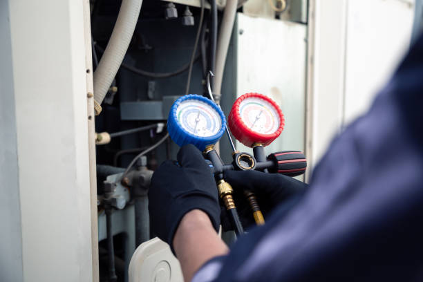 istock Air conditioning, HVAC service technician using gauges to check refrigerant and add refrigerant,Air Conditioning Repair, repairman on the floor fixing air conditioning system. 2170619360