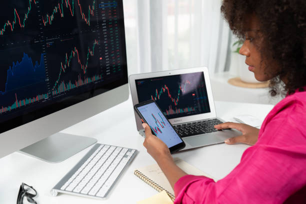 istock African woman blogger looking on computer screen and smartphone. Tastemaker. 2170620485