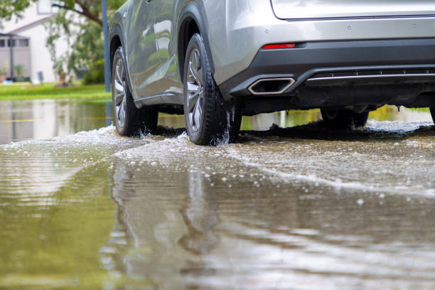 istock Car driving through flooded road 2170620658