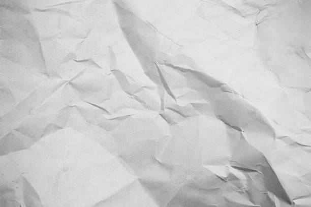 A textured background of crumpled white paper.
