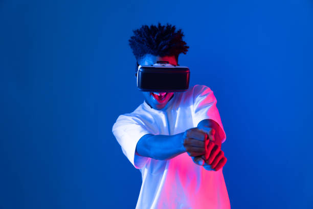 istock African American player wearing VR playing sword baseball to meta. Contrivance. 2170628038