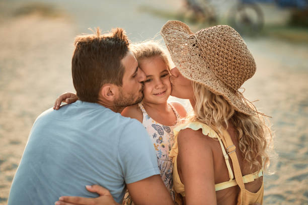 Beautiful family enjoying sunset on a beach vacation.
