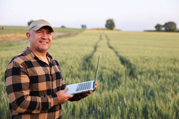 istock Farmer working with laptop on wheat field. 2170629211