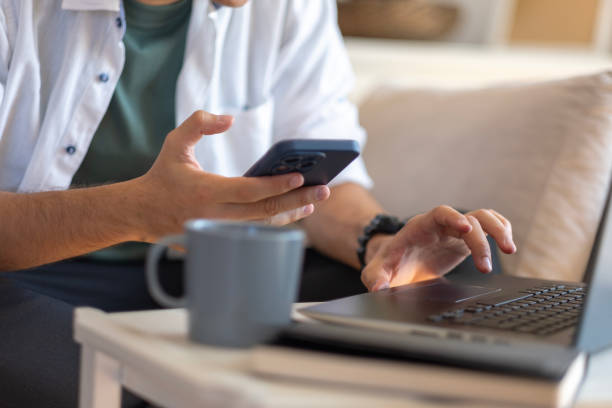Close-up of unknown man's hands texting on phone
