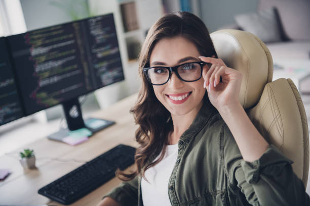 istock Photo of smiling intelligent lady software expert nerd sit chair modern office write content plan report removal bug indoor workstation 2170631598