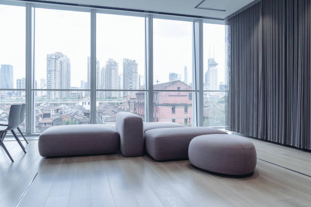 istock A spacious, modern lounge area with large floor-to-ceiling windows offering a panoramic view of an urban landscape 2170631642