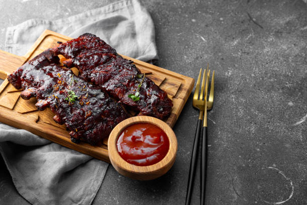 istock Roasted Pork Ribs in BBQ Sauce on the grey background 2170633450