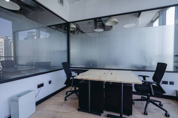 istock A modern conference room with large floor-to-ceiling windows that offer a stunning view of high-rise buildings 2170633573