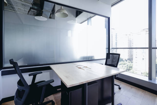 istock A modern conference room with large floor-to-ceiling windows that offer a stunning view of high-rise buildings 2170634132