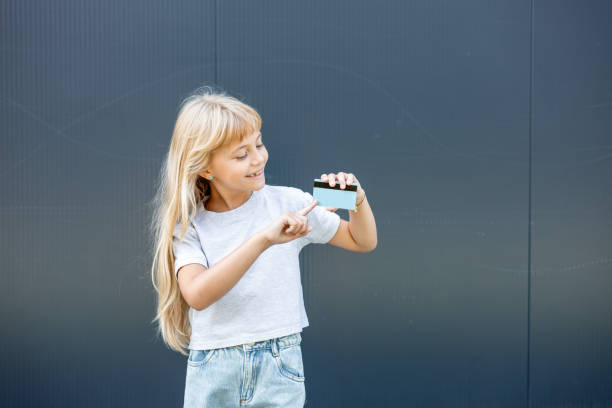 istock Little girl is holding a card 2170636752