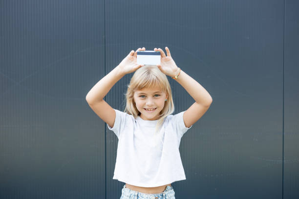 istock Little girl is holding a card 2170636827