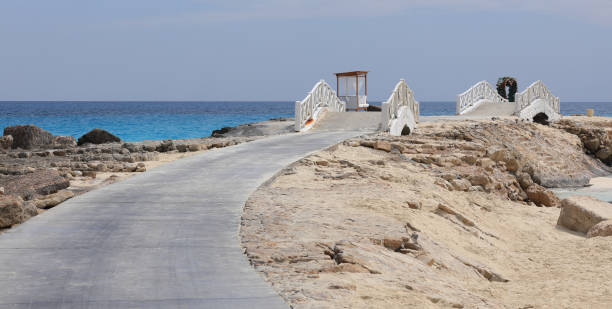 old wooden white bridge on the sea