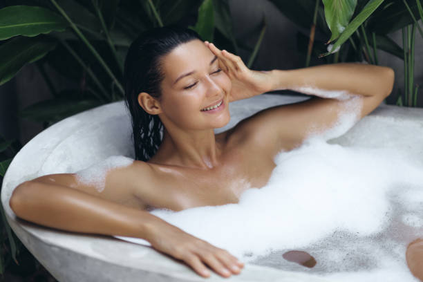 istock Woman Relaxing in Bubble Bath in Tropical Outdoor Setting 2170638638