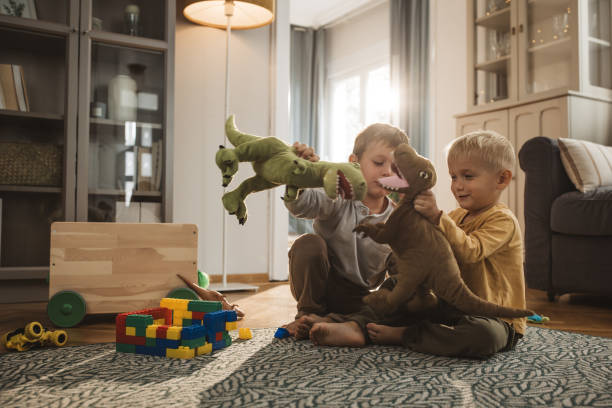 istock Kids playing with toys on the floor 2170642123