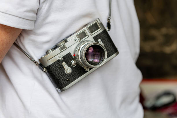 istock A person carrying a vintage photo camera. 2170643800