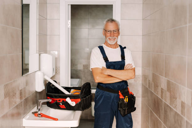istock Senior plumber smiling with arms crossed in bathroom 2170643864