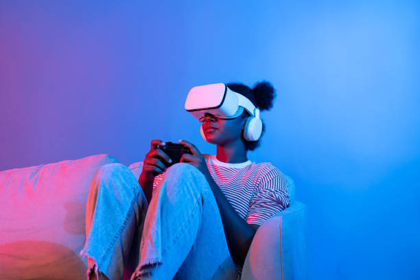 istock Smiling African playing gaming player wearing VR control joystick. Contrivance. 2170644465