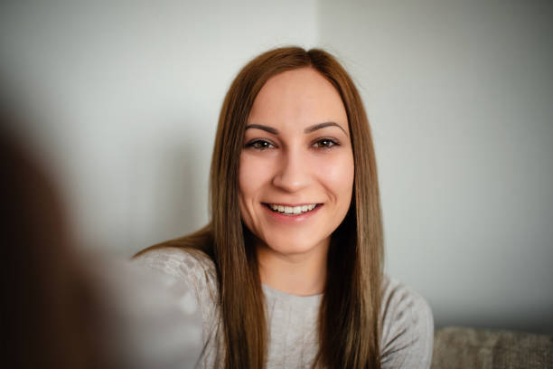 istock young woman smiling in selfie indoors 2170644722