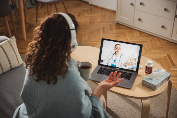 istock Young woman having online doctor's appointment at home 2170649715
