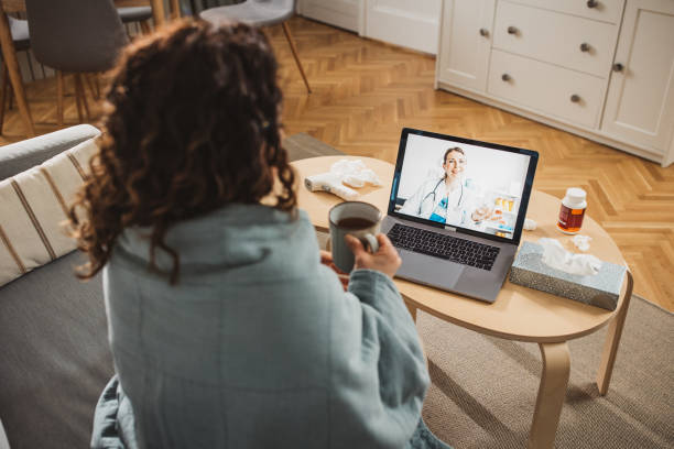 istock Young woman having online doctor's appointment at home 2170650029
