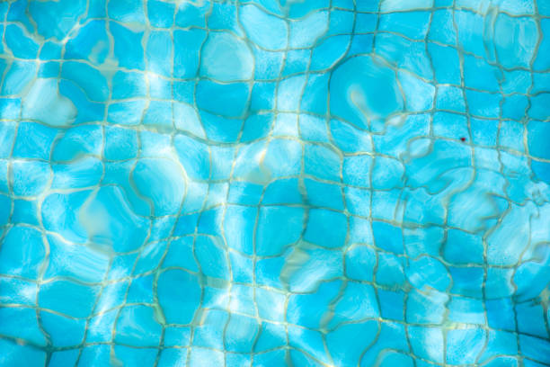 Crystal-clear water in a swimming pool, reflecting a pristine and inviting atmosphere for relaxation and enjoyment