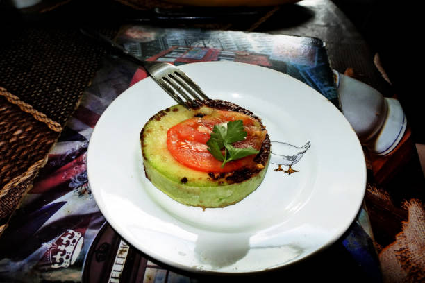 istock Fried zucchini slices with crispy crust, tomatoes, herbs and garlic 2170653554
