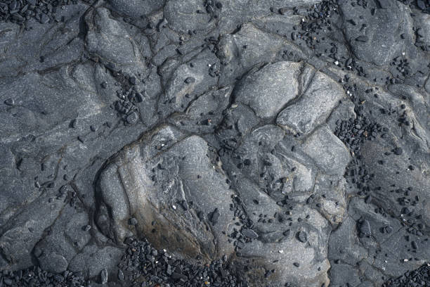 Dark natural rock background with fine stone chips, directly above view