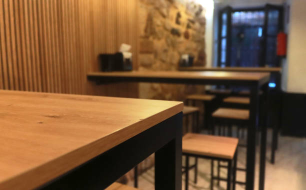 istock Minimalist interior of a modern restaurant with wooden tables and stools 2170655096