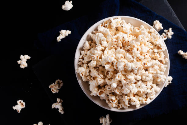 istock Food concept popcorn in ceramic bowl on black background with copy space 2170655546