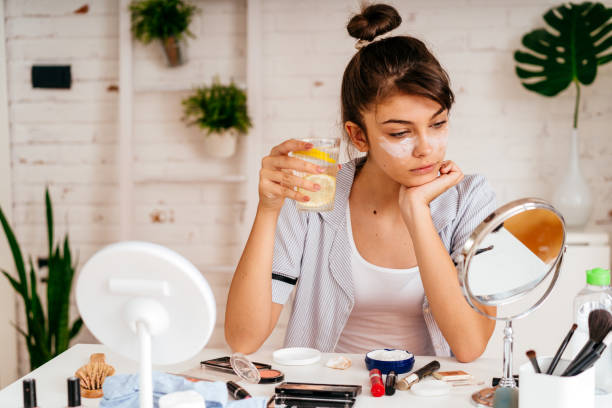 istock Young woman applying moisturizer cream on her face 2170656241