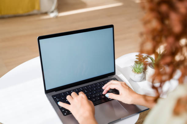 istock Freelancer working from home typing on laptop with blank screen 2170656275