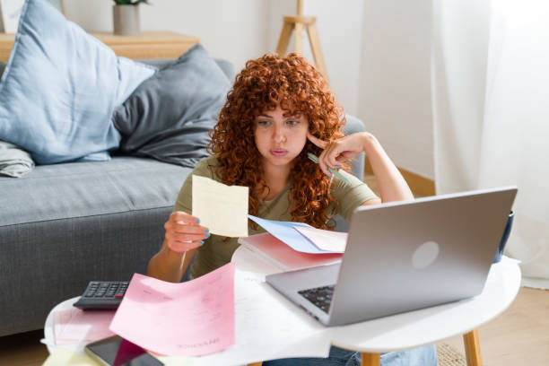 Young woman managing finances and bills at home