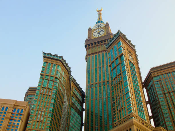 The Clock Towers A low angle view of Makkah Clock Royal Tower or Abraj Al-Bait with its seven skyscraper hotels.. makkah royal clock tower stock pictures, royalty-free photos & images