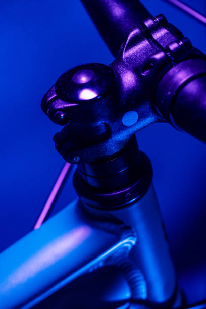 Close-up of bicycle handlebar extension in neon lighting