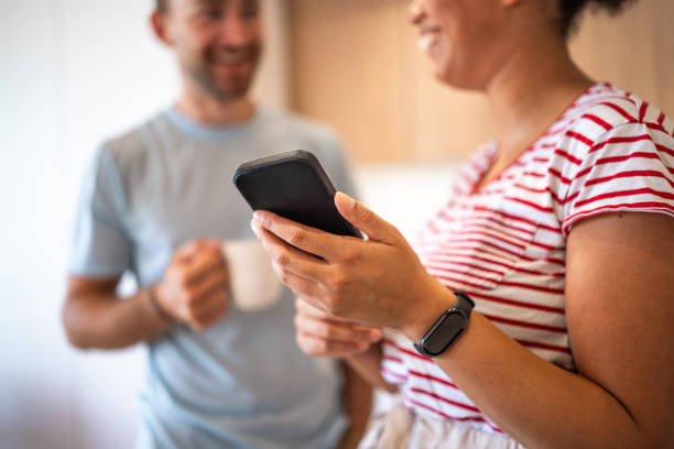 istock Diverse Couple Engages in Mobile Payment at Home 2170658581
