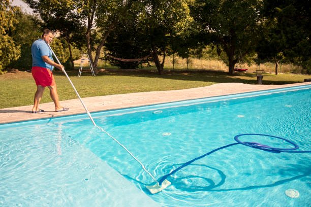 istock Maintenance person cleaning swimming pool 2170658772