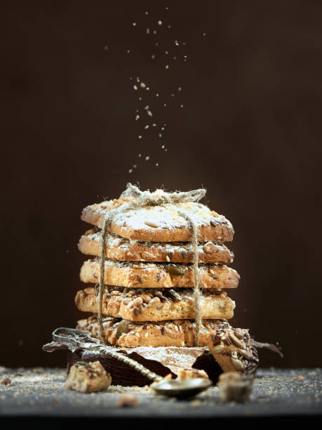 istock Chocolate cookies in a stack tied with a rope are sprinkled with powdered sugar on a brown background. 2170659279