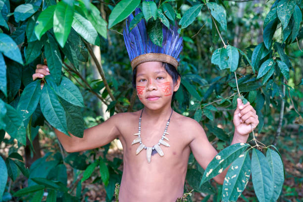 istock A small indigenous boy from the Amazon in the forest looking at the camera 2170659511
