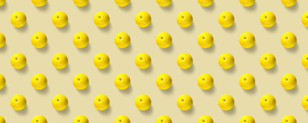 istock Fruit pattern of fresh yellow oranges on yellow background. Pop art design, creative summer concept. 2170659555