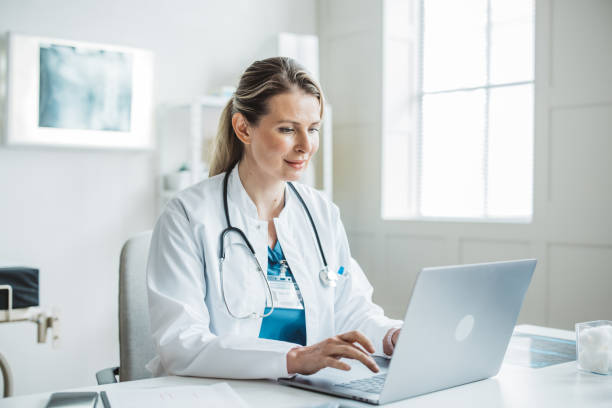 istock Female doctor sitting behind desk in office 2170662725