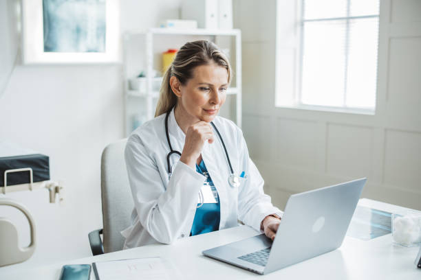 istock Female doctor sitting behind desk in office 2170662729