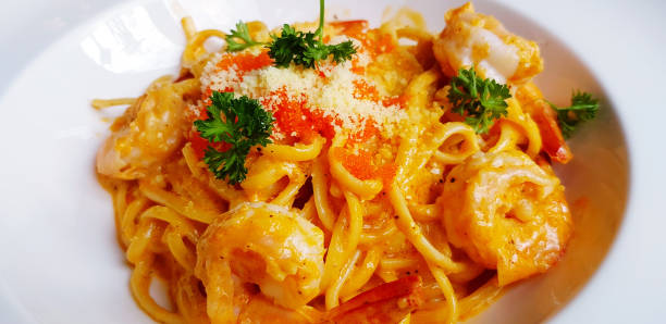 istock Close up Shrimp paste pasta or spaghetti with cheese, Shrimp egg and herb on top in white plate. Italian food concept. 2170663571