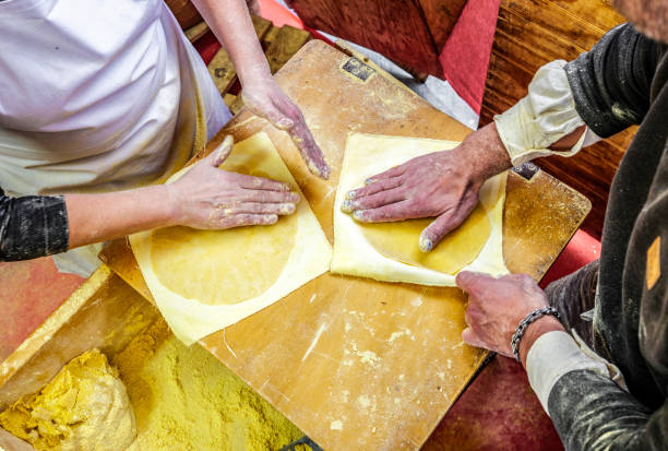 Basque farmers (Baserritarras) making Talos, a Basque tortilla stuffed with fresh chorizo called Txistorra, served as traditional street food during the Day of Saint Thomas.