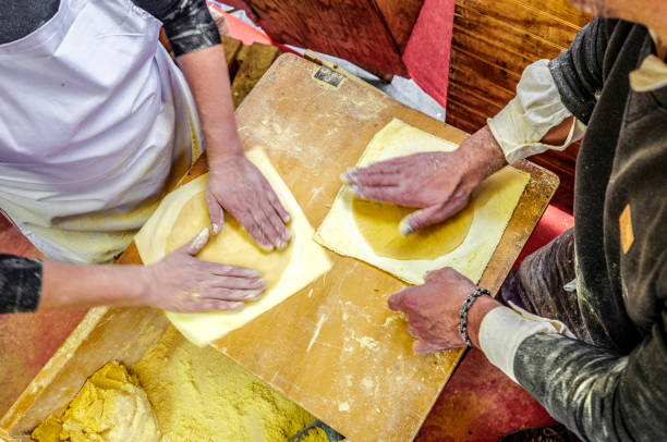 istock Basque farmers (Baserritarras) making Talos, a Basque tortilla stuffed with fresh chorizo called Txistorra, served as traditional street food during the Day of Saint Thomas. 2170663598