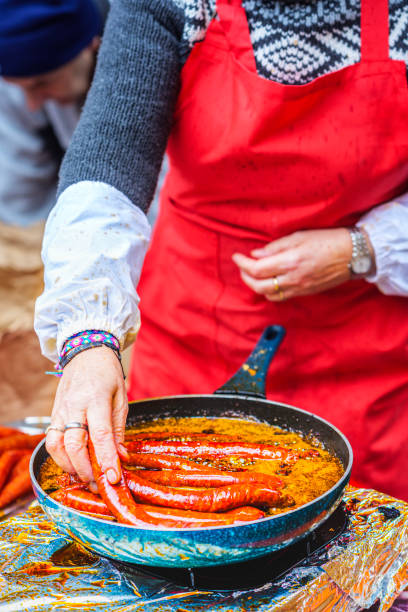 istock A Basque farmer (Baserritarra) frying Txistorra (fresh chorizo) to prepare Bocadillo de Txistorra, served during the Day of Saint Thomas. 2170663600