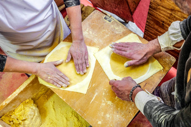 istock Basque farmers (Baserritarras) making Talos, a Basque tortilla stuffed with fresh chorizo called Txistorra, served as traditional street food during the Day of Saint Thomas. 2170663601