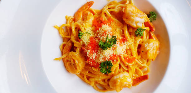 istock Flay lay of Shrimp paste pasta or spaghetti with cheese, Shrimp egg and herb on top in white plate. Italian food concept. 2170663644