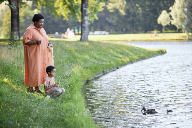 istock Granny and Grandson Feeding Ducks 2170672057