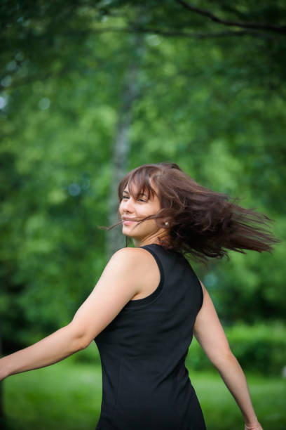 istock Happy woman spinning in the park 2170673963